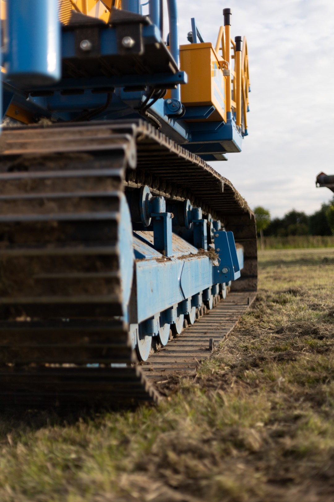 A vertical shot of large industrial machinery on a meadow